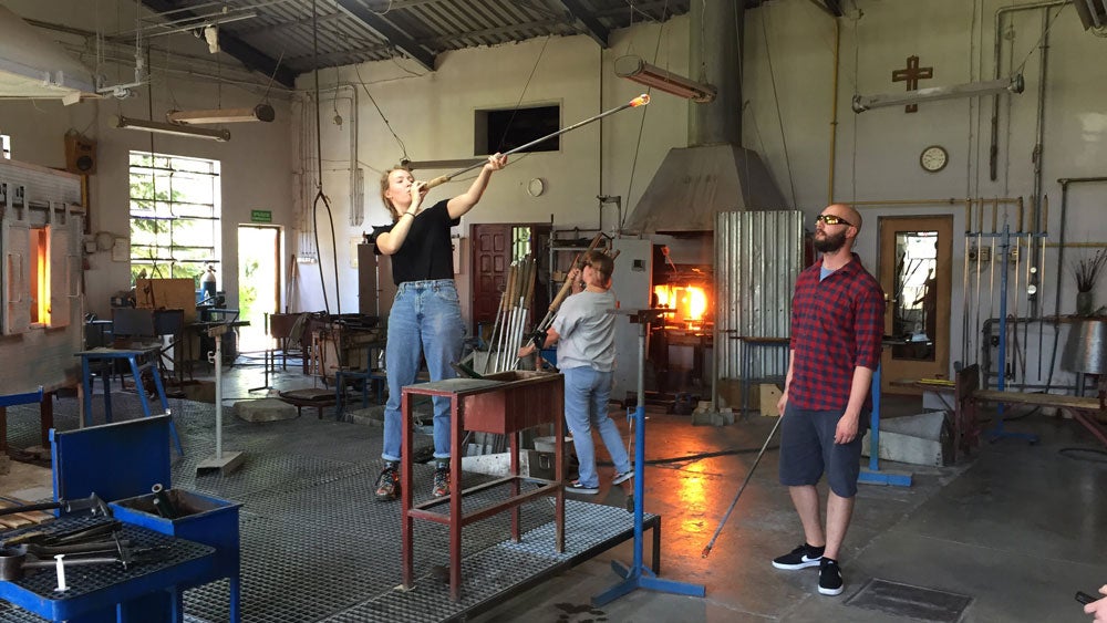Students working in a glass blowing studio